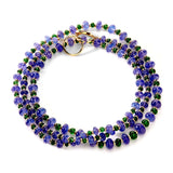 An excellent blue and green stones necklace, 36 inches in length, strung on a silk thread with a circular diamond clasp.